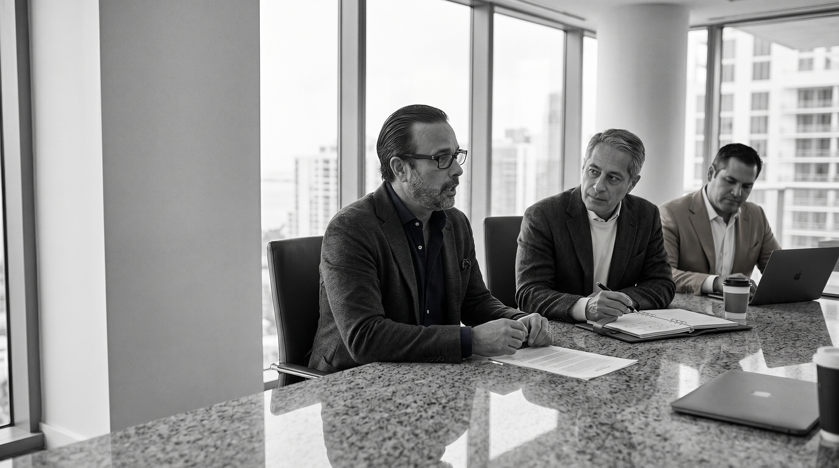 The three founding partners at the conference table.